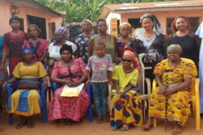 group of women are standing and sitting